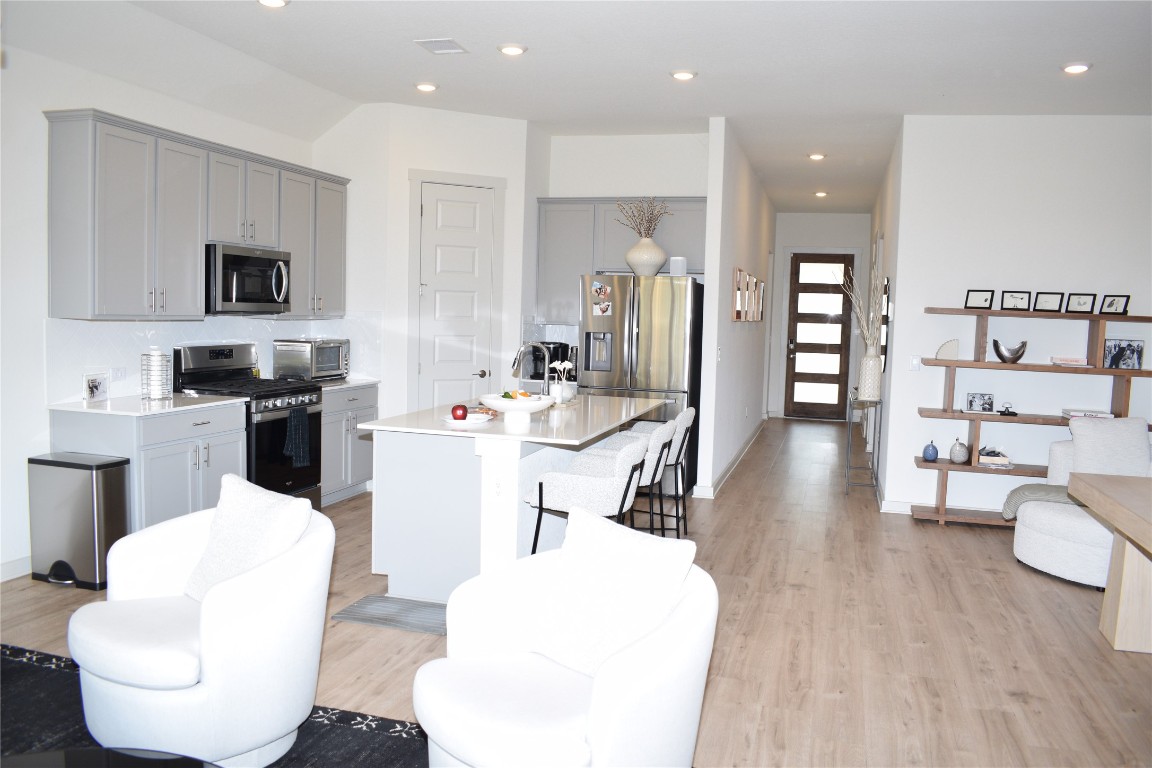 2409 Bear Cub Bend Leander, TX 78641 - Photo 6 of 37 a living room with furniture and a wooden floor