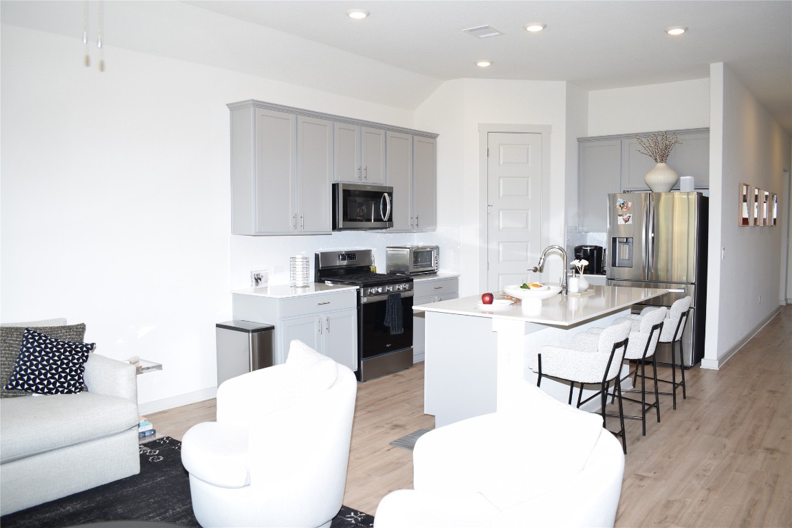 2409 Bear Cub Bend Leander, TX 78641 - Photo 7 of 37 a living room with furniture and a wooden floor