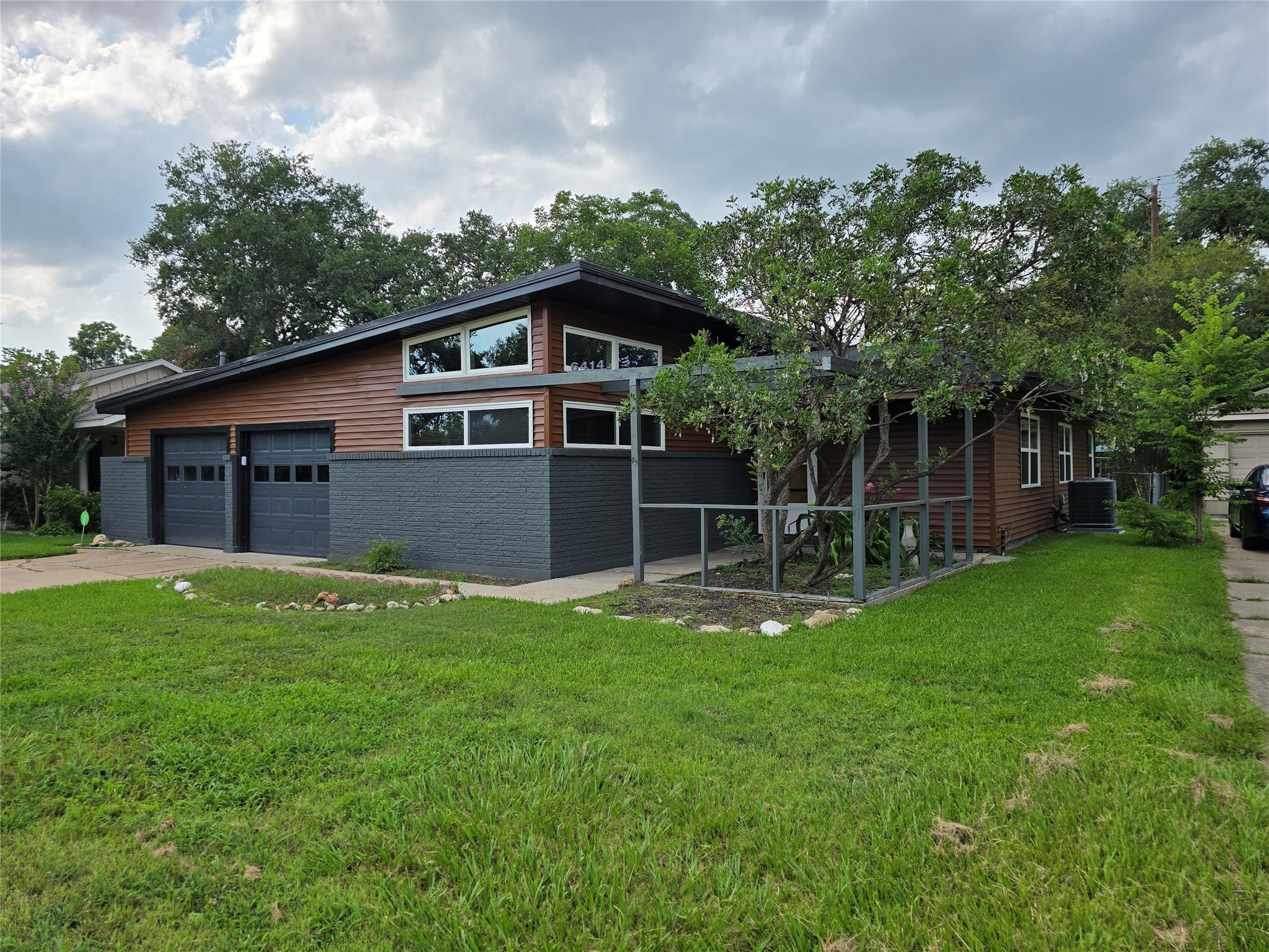 a view of a house with a yard and sitting area