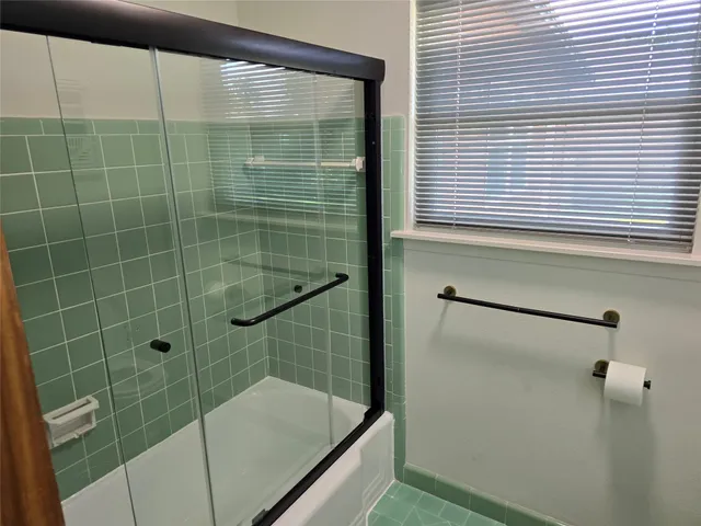 a bathroom with a shower and a sink