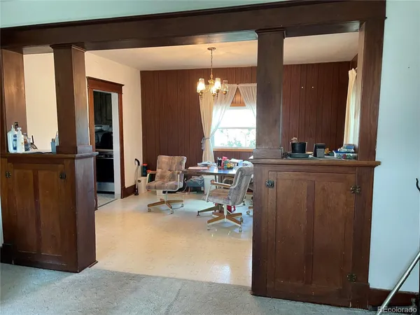 a view of a hallway with living room and dining room