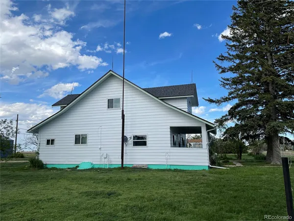 a front view of house with a garden