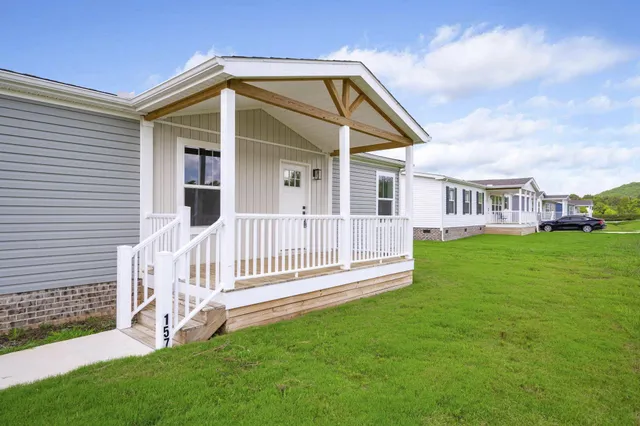 a front view of a house with a garden and deck