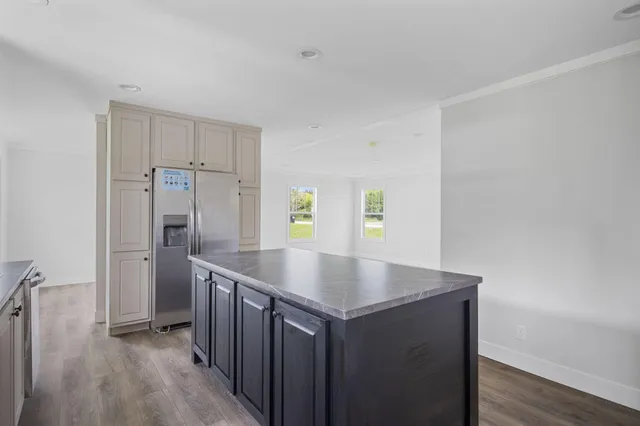 a kitchen with stainless steel appliances granite countertop a sink a stove and cabinets