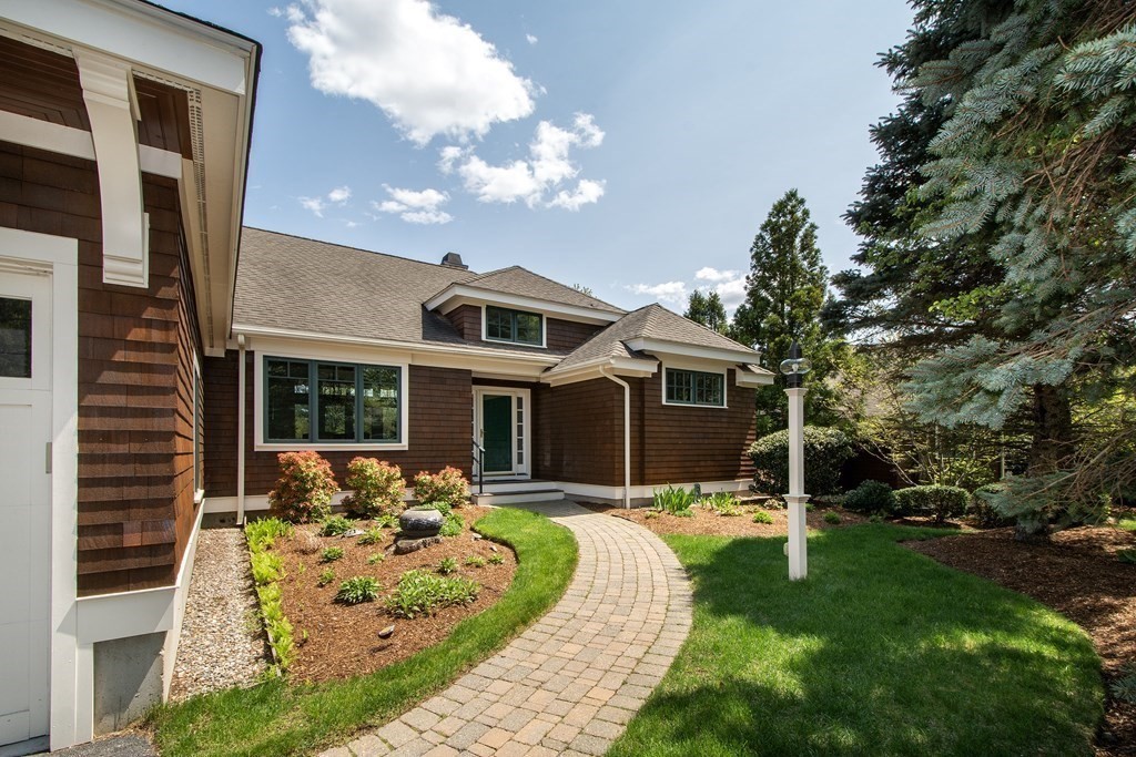 7 Tillinghast Drive, Unit 7 Hingham, MA 02043 - Photo 1 of 42 a front view of a house with a yard table and chairs