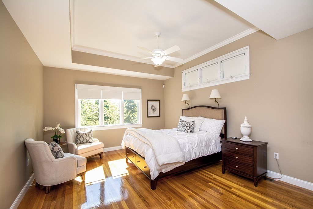 7 Tillinghast Drive, Unit 7 Hingham, MA 02043 - Photo 25 of 42 a bedroom with a bed and wooden floor