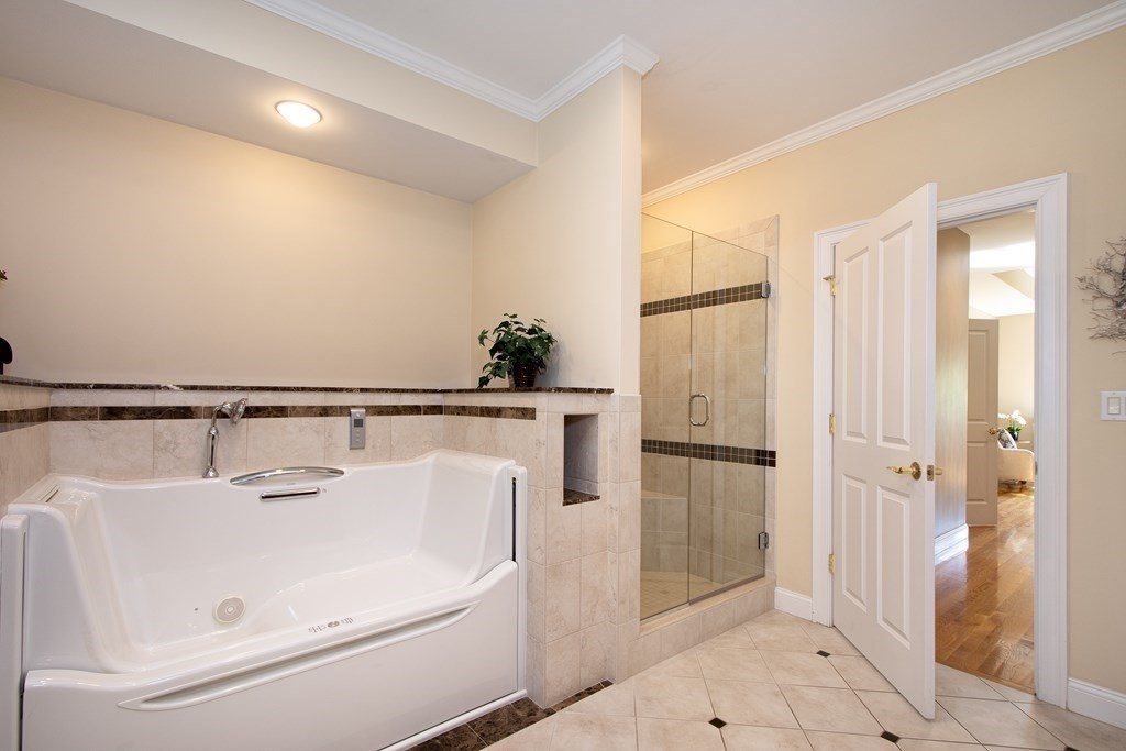 7 Tillinghast Drive, Unit 7 Hingham, MA 02043 - Photo 29 of 42 a white bath tub sitting next to a white sink