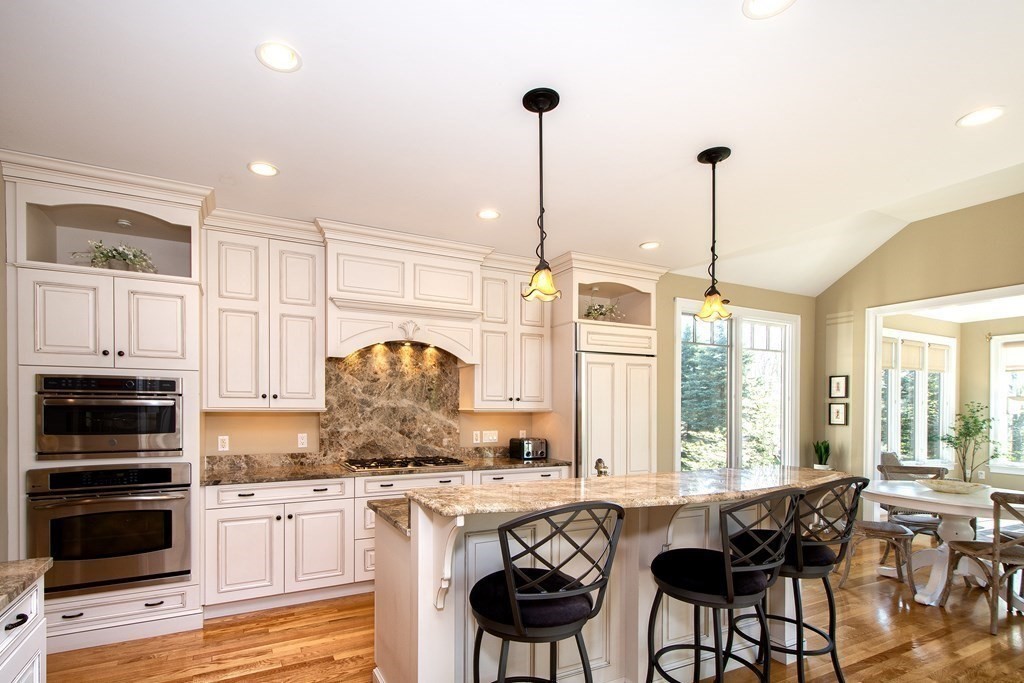 7 Tillinghast Drive, Unit 7 Hingham, MA 02043 - Photo 4 of 42 a kitchen with stainless steel appliances granite countertop a stove and cabinets