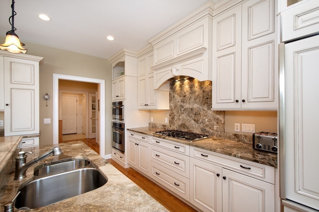7 Tillinghast Drive, Unit 7 Hingham, MA 02043 - Photo 9 of 42 a kitchen with stainless steel appliances granite countertop a sink and cabinets