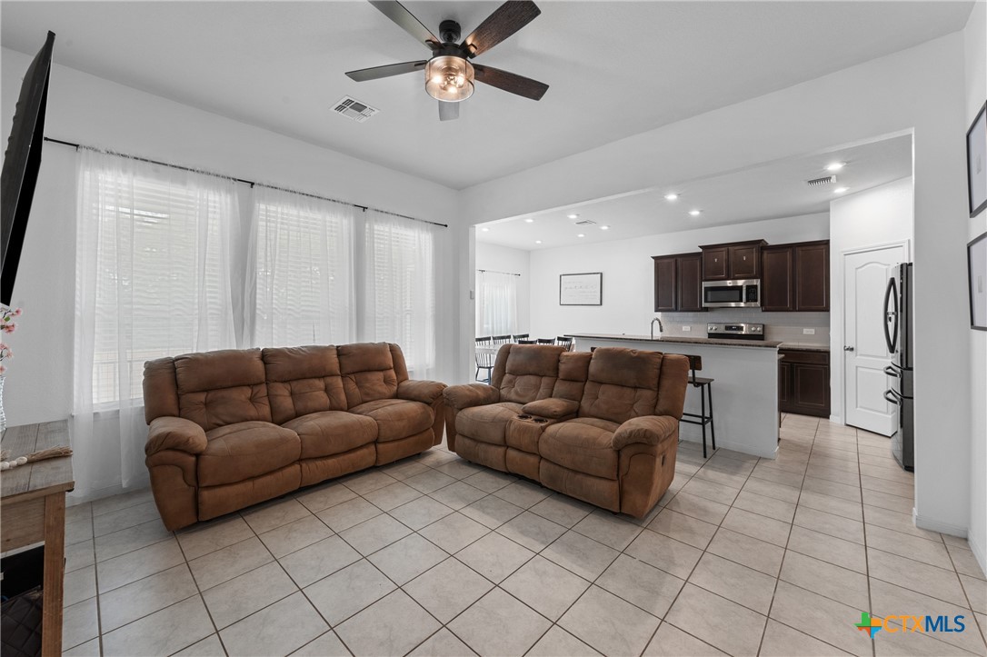 a living room with furniture and kitchen view