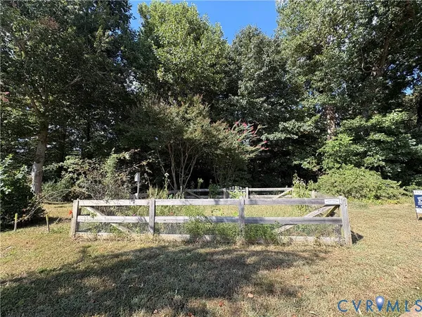 a view of a yard with wooden fence