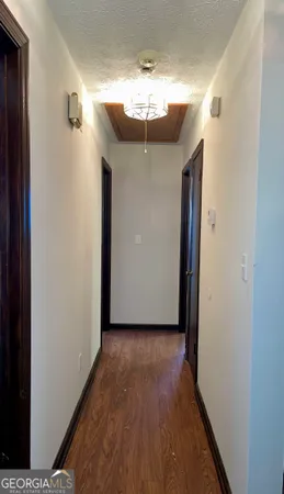 a view of a hallway with wooden floor