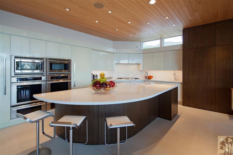 70205 Thunderbird Road Rancho Mirage, CA 92270 - Photo 12 of 25 a kitchen with stainless steel appliances kitchen island granite countertop a sink and chairs