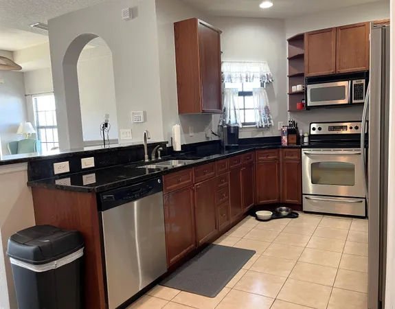a kitchen with a sink stove and microwave