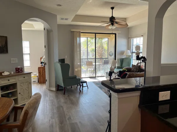 a dining room with wooden floor and a chandelier
