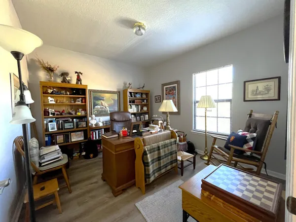 a living room with furniture workspace and a window