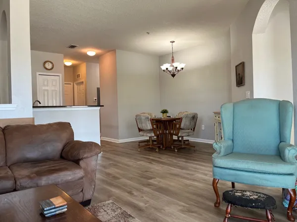 a living room with furniture and a chandelier