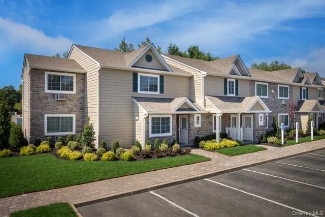 a front view of a house with a garden and plants