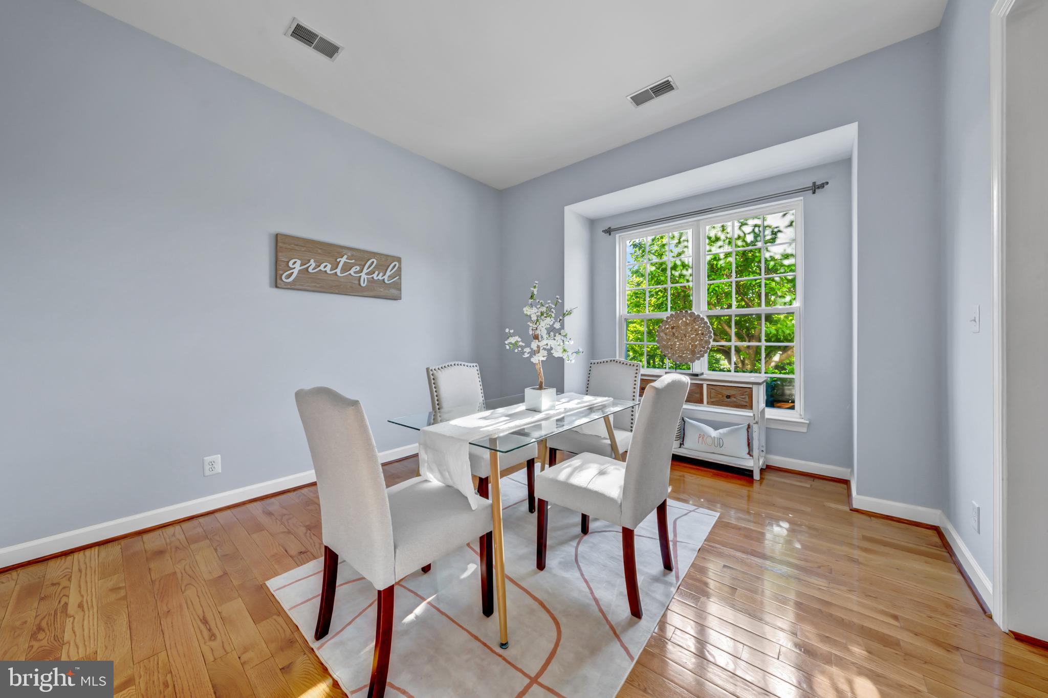 9231 Ribbon Falls Loop Bristow, VA 20136 - Photo 16 of 40 a dining room with a wooden table and chairs