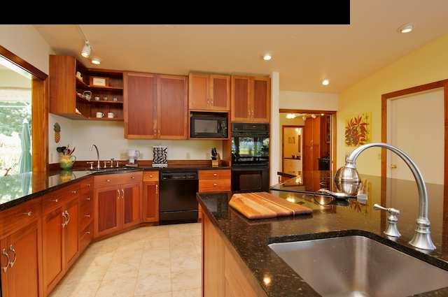 1011 Upper Ulumalu Road, Unit A Haiku, HI 96708 - Photo 4 of 30 a kitchen with stainless steel appliances granite countertop a sink a stove and a refrigerator
