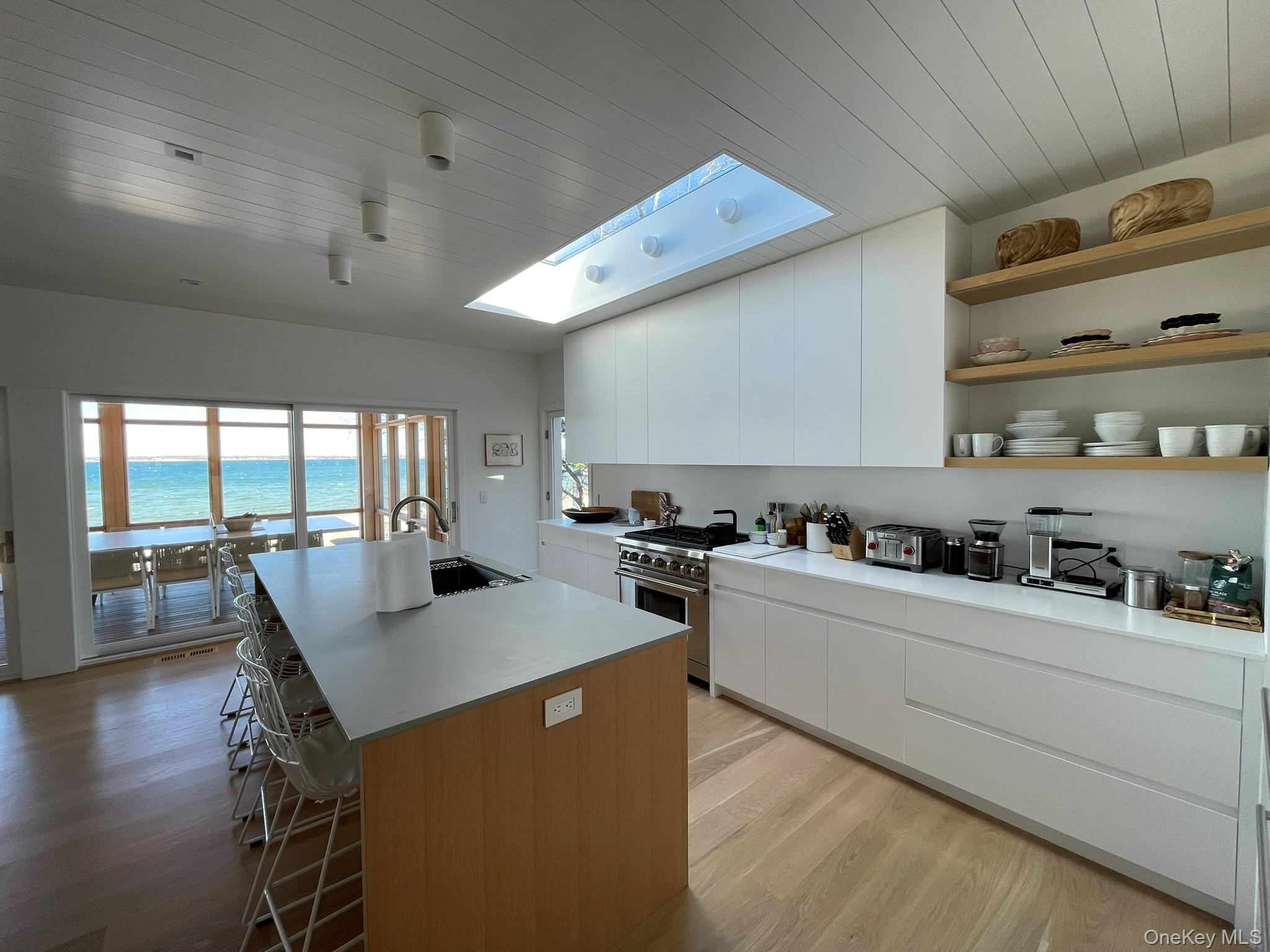 495 North Parish Drive Southold, NY 11971 - Photo 6 of 21 a kitchen with a table chairs stove and cabinets