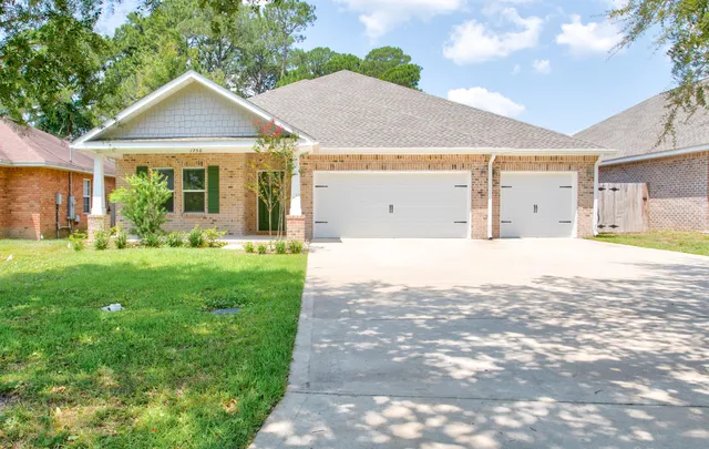 a front view of a house with garden