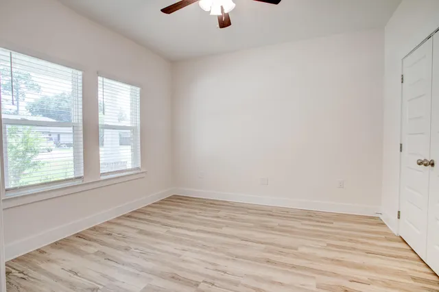 wooden floor in an empty room with a window