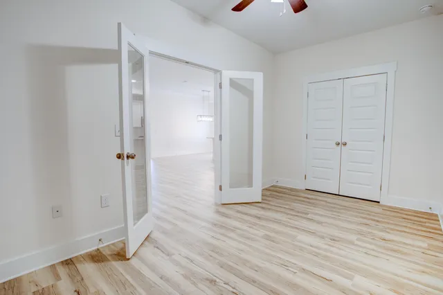 a view of an empty room with wooden floor