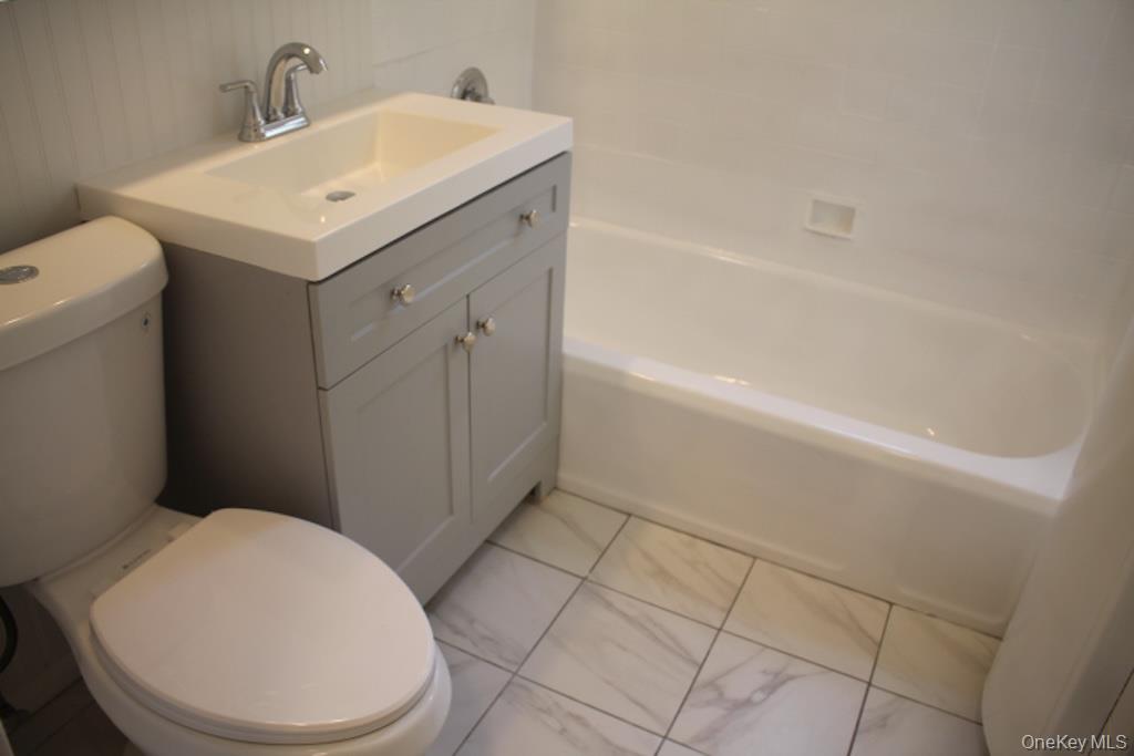 766 Palmer Road, Unit 2F Bronxville, NY 10708 - Photo 11 of 22 Full bath featuring vanity, bathing tub / shower combination, and light marble finish floors