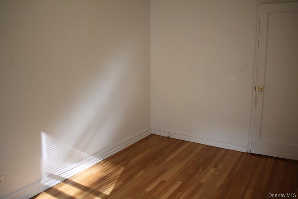 766 Palmer Road, Unit 2F Bronxville, NY 10708 - Photo 15 of 22 Spare room featuring baseboards and wood finished floors