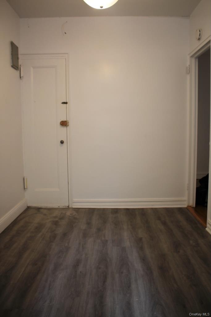 766 Palmer Road, Unit 2F Bronxville, NY 10708 - Photo 9 of 22 Empty room with dark wood-style flooring and baseboards