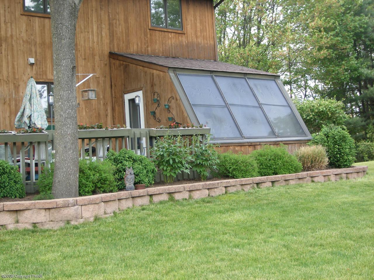 221 Edgemont Road Stroudsburg, PA 18360 - Photo 28 of 30 Rear Stone Lined Flower Beds & Sun Room