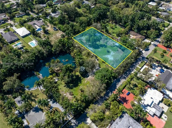 an aerial view of a residential houses with outdoor space and street view