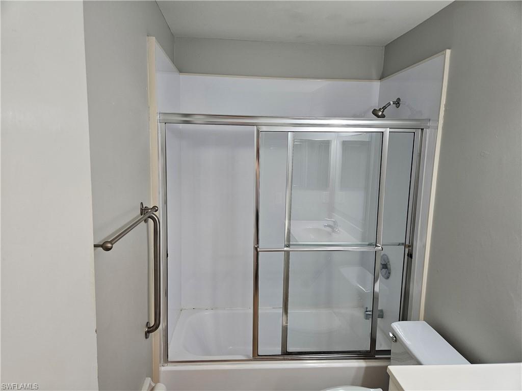 3325 Airport-Pulling Road, Unit D7 Naples, FL 34105 - Photo 8 of 17 Bathroom with enclosed tub / shower combo and toilet