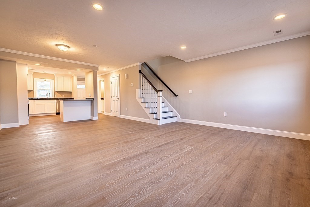 49 Riverside Drive, Unit 49A Lakeville, MA 02347 - Photo 11 of 31 an empty room with wooden floor and windows