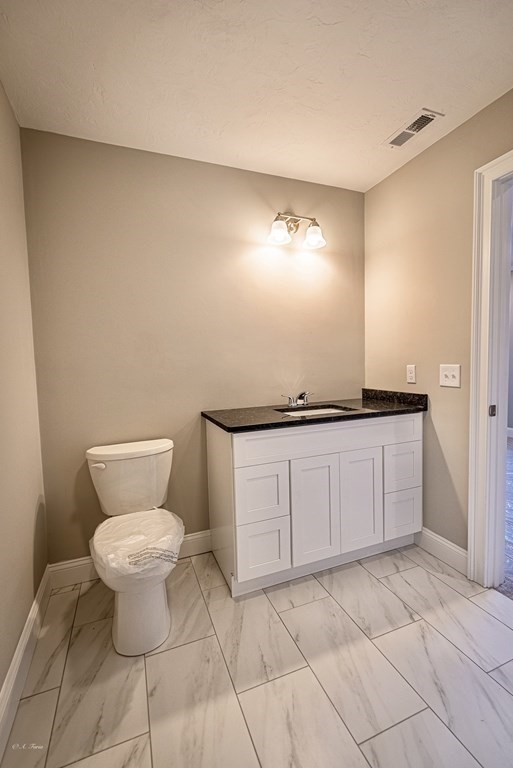 49 Riverside Drive, Unit 49A Lakeville, MA 02347 - Photo 14 of 31 a bathroom with a toilet and a vanity