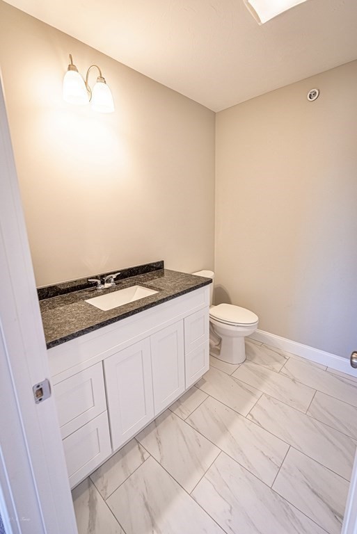 49 Riverside Drive, Unit 49A Lakeville, MA 02347 - Photo 20 of 31 a bathroom with a granite countertop sink and a toilet