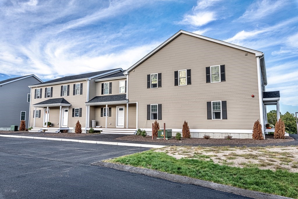 49 Riverside Drive, Unit 49A Lakeville, MA 02347 - Photo 2 of 31 a front view of a house with a yard