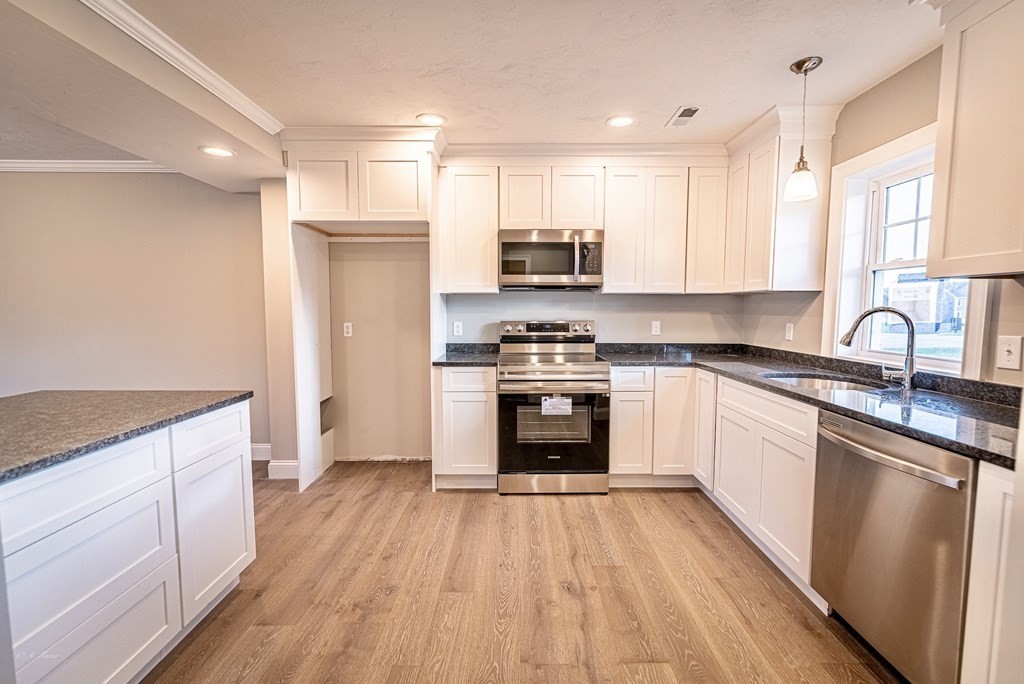 49 Riverside Drive, Unit 49A Lakeville, MA 02347 - Photo 5 of 31 a kitchen with granite countertop a sink cabinets and stainless steel appliances