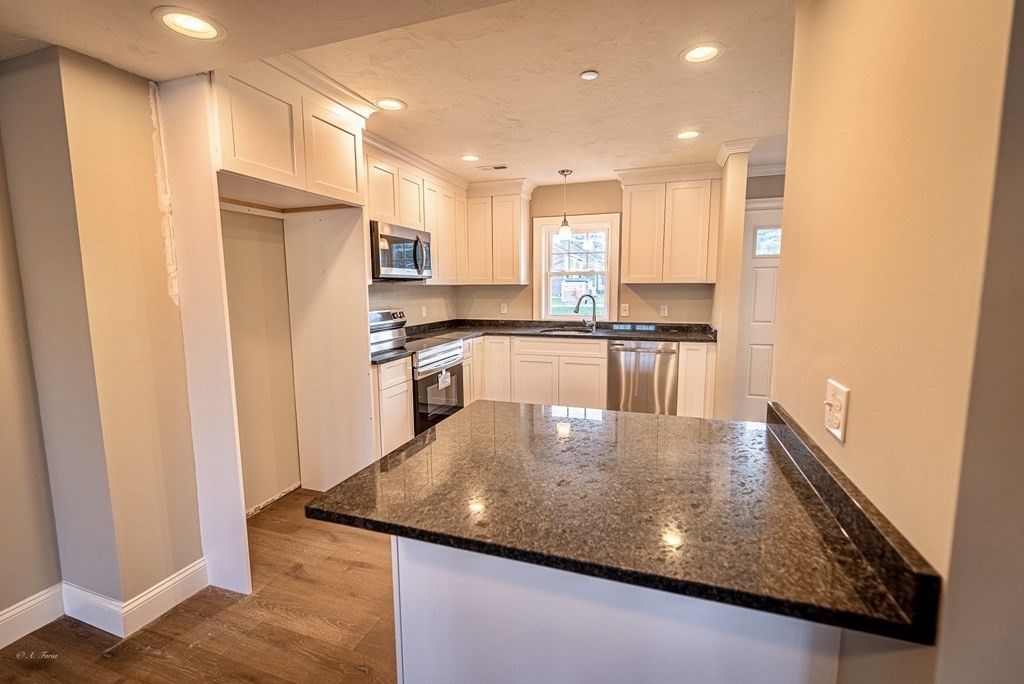 49 Riverside Drive, Unit 49A Lakeville, MA 02347 - Photo 9 of 31 a kitchen with stainless steel appliances granite countertop a refrigerator a stove and a sink