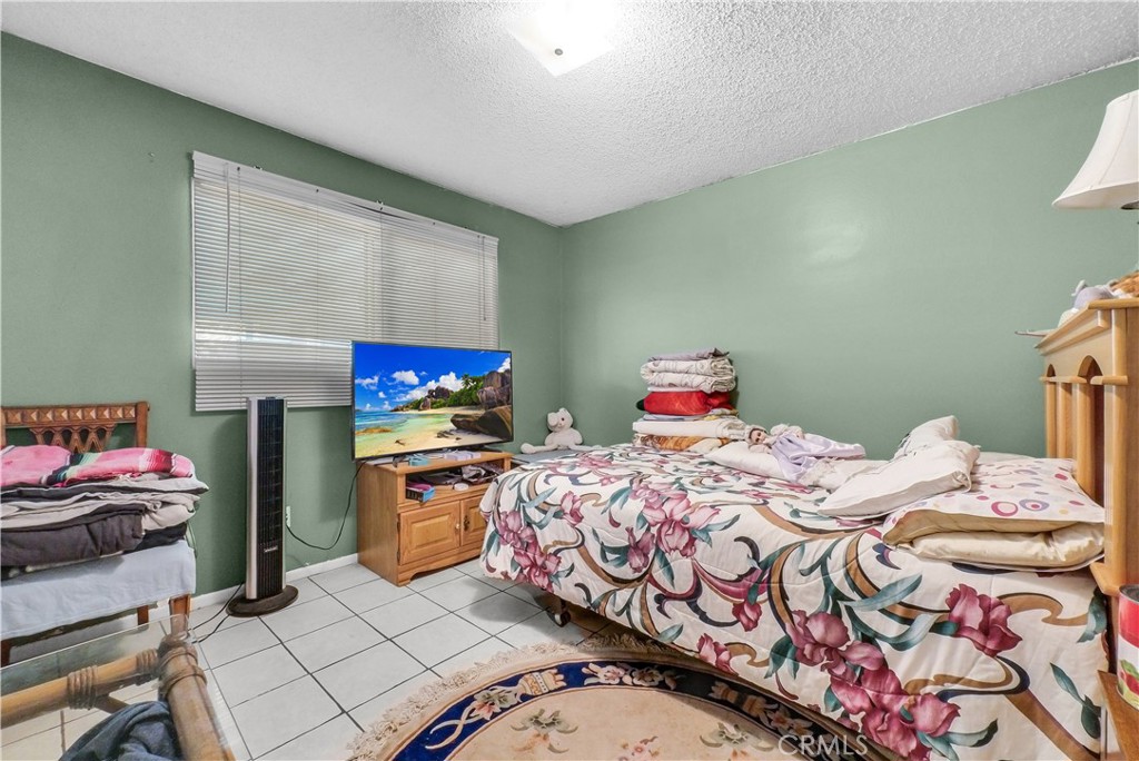 3261 Viola Drive Riverside, CA 92501 - Photo 11 of 21 a bedroom with a bed and a window