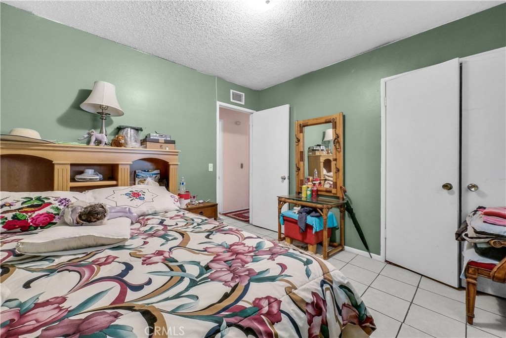 3261 Viola Drive Riverside, CA 92501 - Photo 12 of 21 a bedroom with a bed a dresser and book shelf