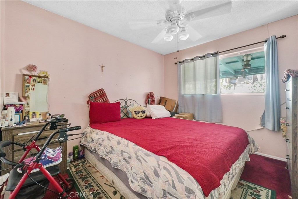 3261 Viola Drive Riverside, CA 92501 - Photo 18 of 21 a bedroom with a bed and a chandelier