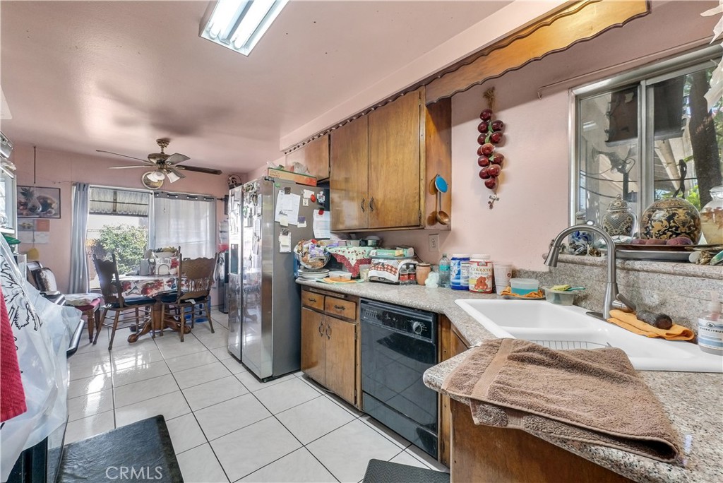 3261 Viola Drive Riverside, CA 92501 - Photo 6 of 21 a kitchen that has a sink and chairs in it