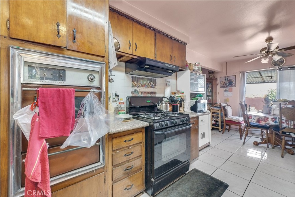 3261 Viola Drive Riverside, CA 92501 - Photo 7 of 21 a kitchen with stainless steel appliances granite countertop a stove and cabinets