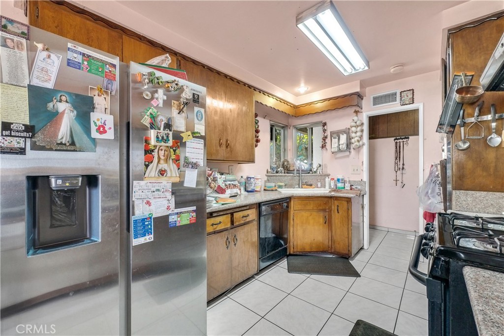 3261 Viola Drive Riverside, CA 92501 - Photo 8 of 21 a kitchen with stainless steel appliances granite countertop a refrigerator and a stove