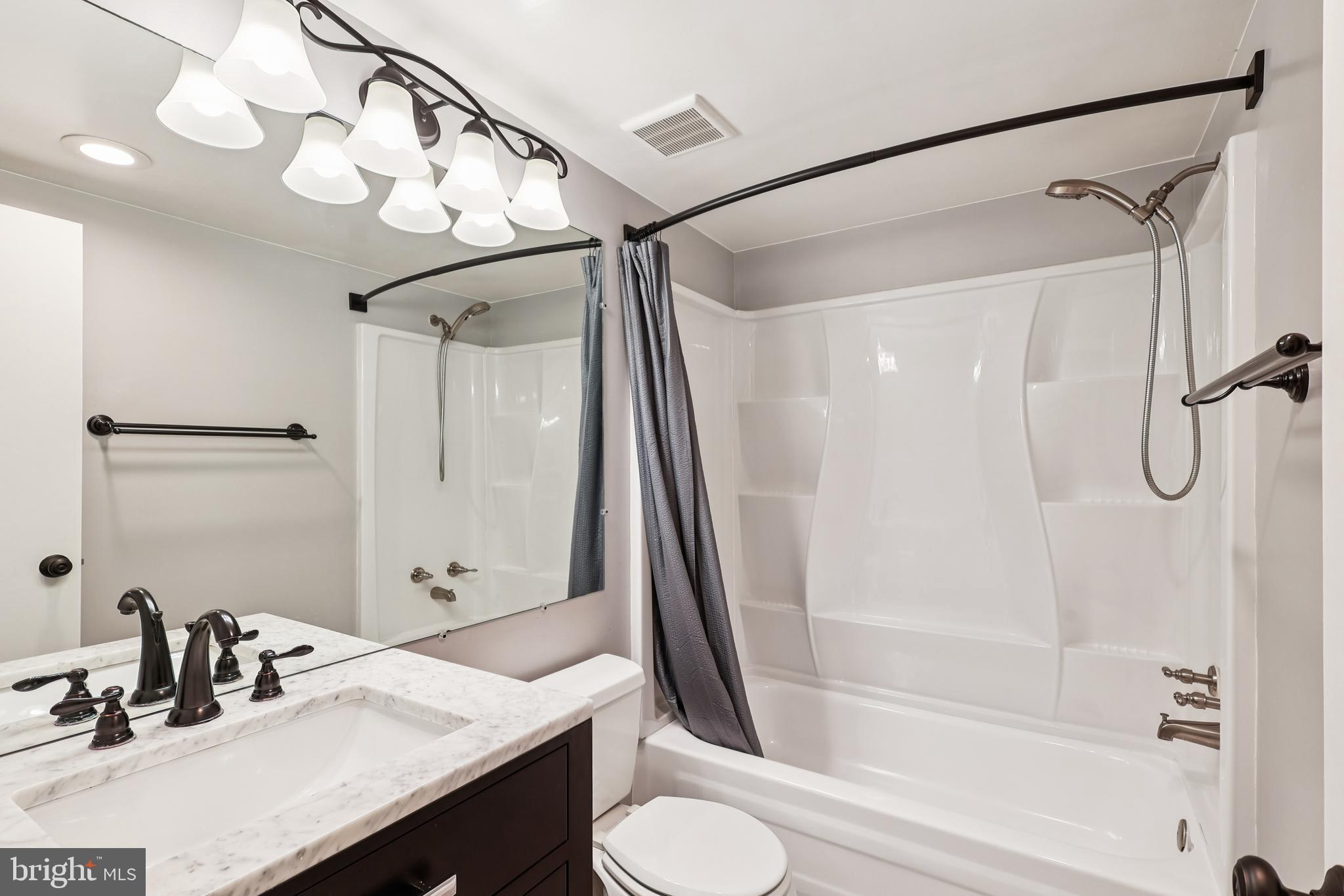 10 Silverwood Circle, Unit 10 Annapolis, MD 21403 - Photo 13 of 58 a bathroom with a sink a toilet and shower