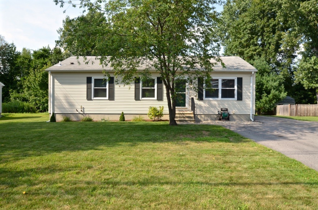 a front view of house with yard and green space