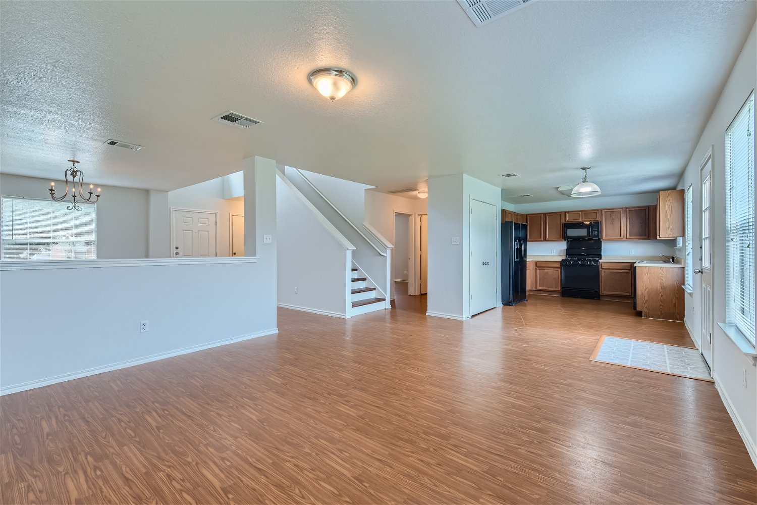 18408 Cloudmore Lane Elgin, TX 78621 - Photo 11 of 11 An open floorplan connects the well-lit living space to the functional kitchen and adjacent dining area.