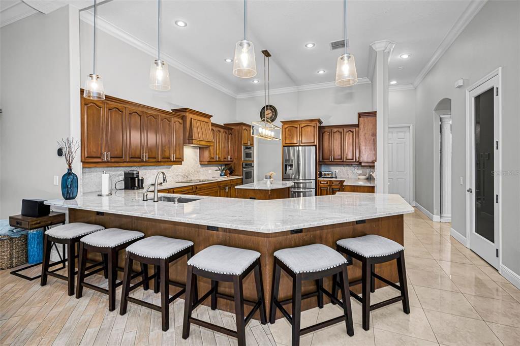 10709 Watula Court New Port Richey, FL 34655 - Photo 21 of 99 a large kitchen with a table and chairs